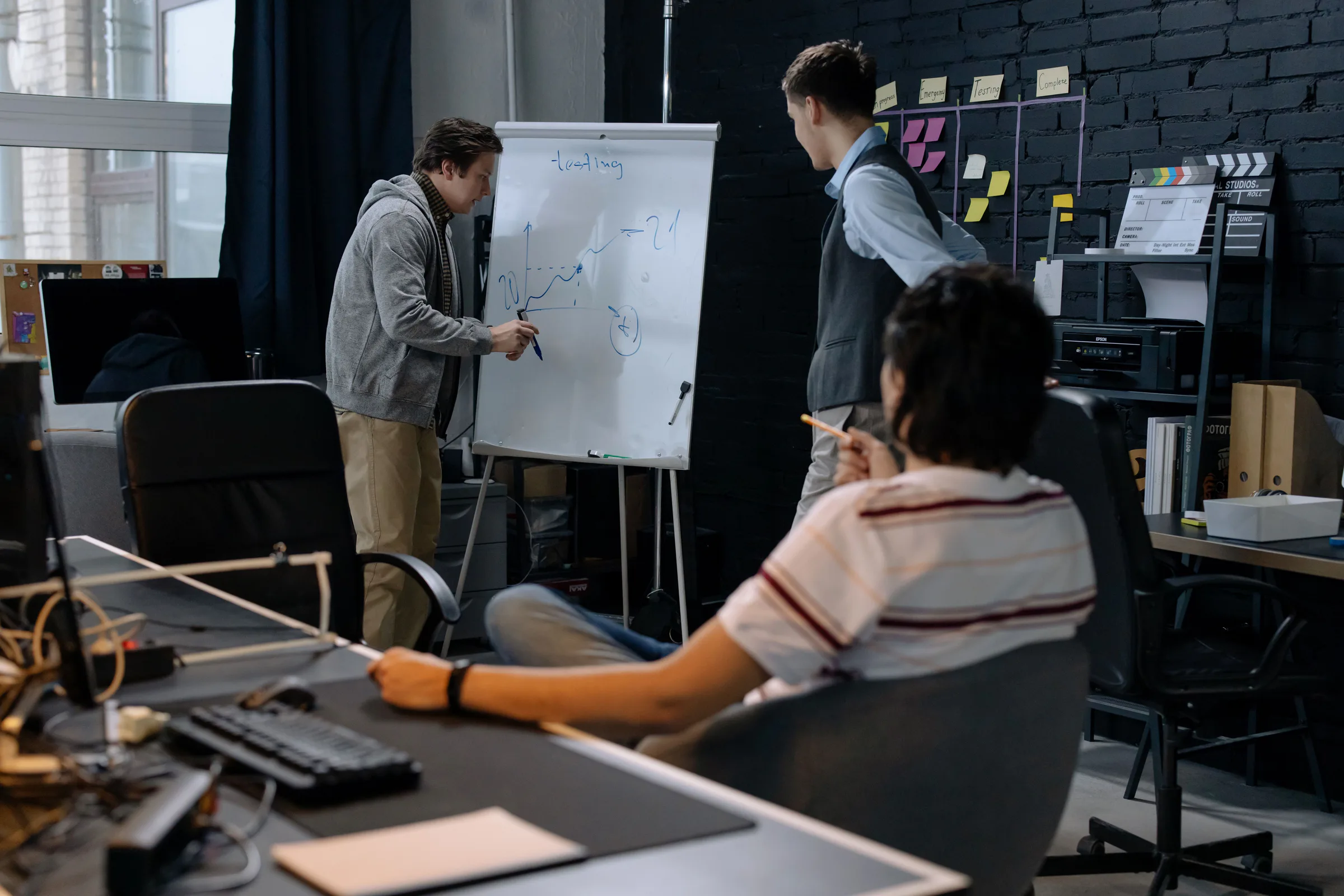 A team designing a shared workflow at a whiteboard
