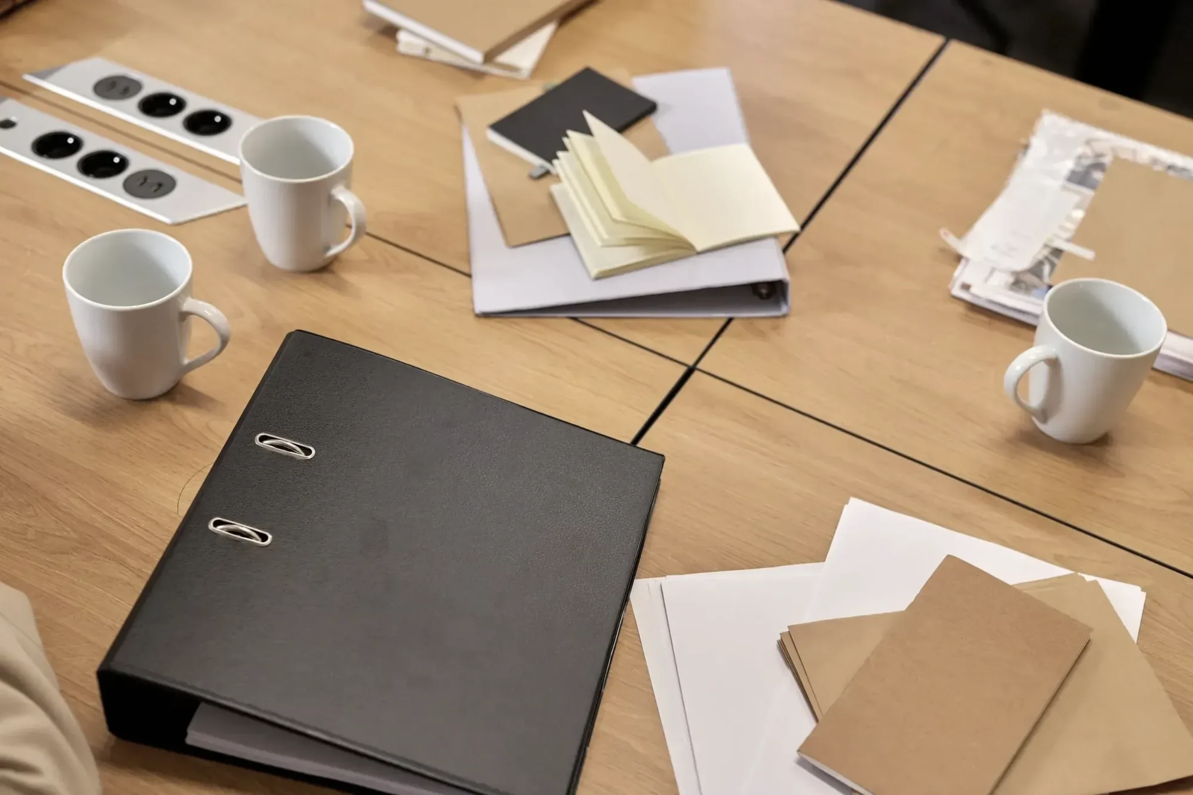 Working notes and binders open across a services desk