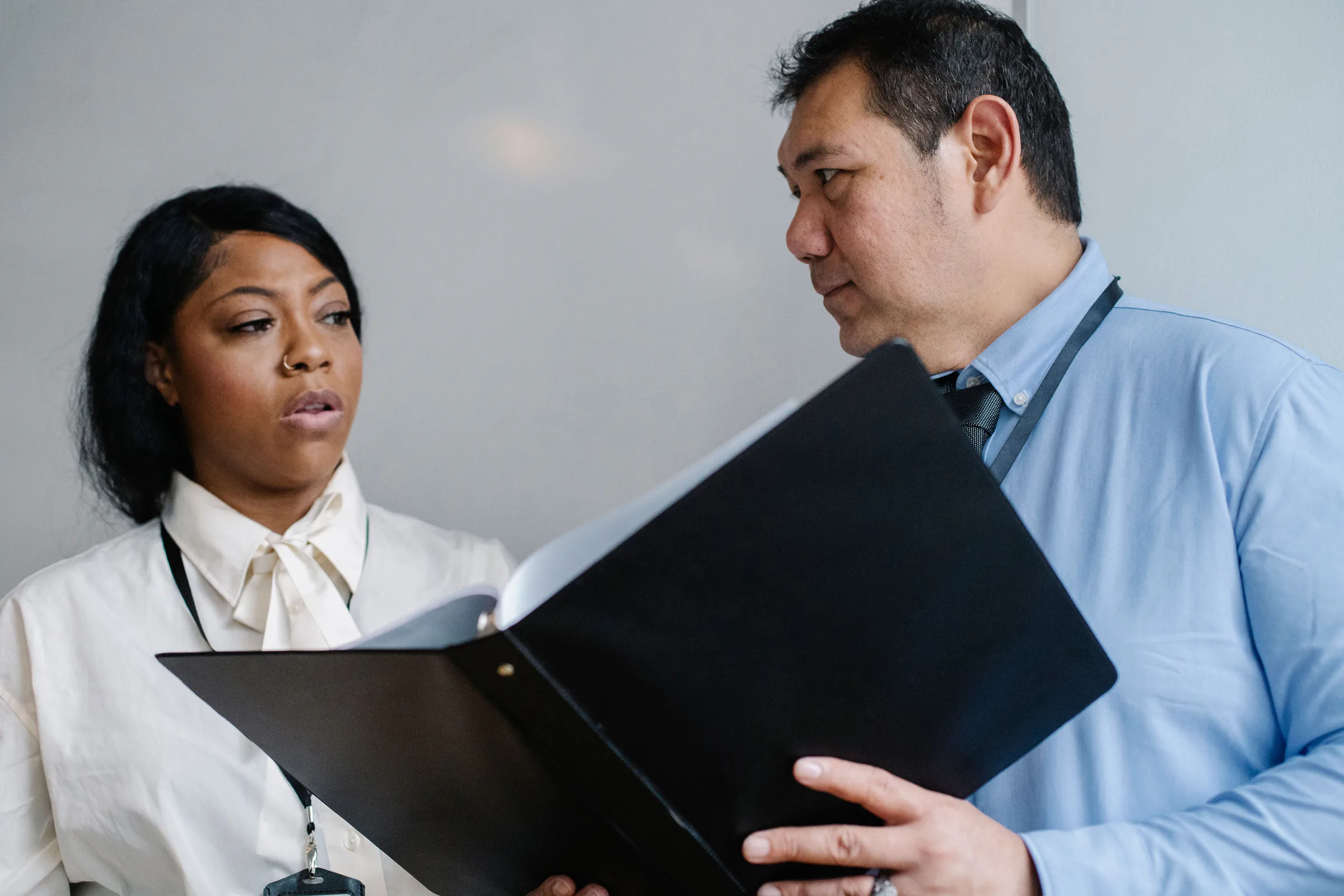 A manager walking an employee through written work instructions